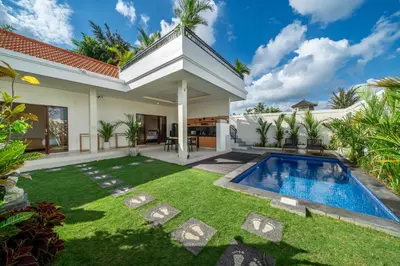 a backyard with a swimming pool and a house at Aleksa - Villa with Rooftop&Rice Field View in Canggu