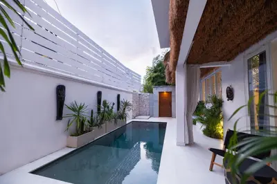 a swimming pool in the middle of a house at Villa Karibu Canggu-2BR with pool & rooftop in Canggu
