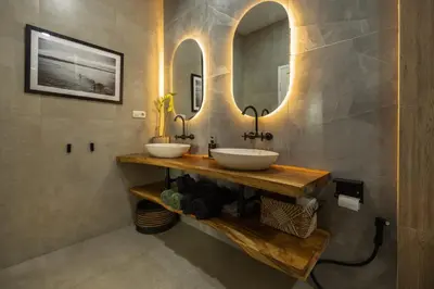 two sinks in a bathroom with two mirrors at Villa Karibu Canggu-2BR with pool & rooftop in Canggu