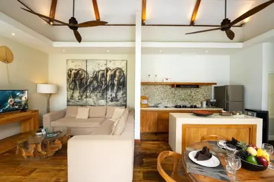 two views of a living room and a kitchen at Villa Chloe by Pertama Management in Seminyak