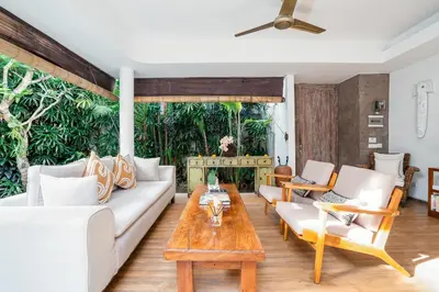 a living room with a couch and a table at Villa Casa Coral at Umalas in Kerobokan
