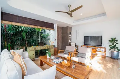 a living room with a couch and a table at Villa Casa Coral at Umalas in Kerobokan