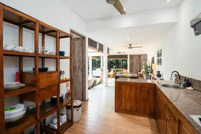 a kitchen with wooden cabinets and a counter top at Villa Casa Coral at Umalas in Kerobokan