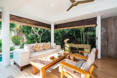 a living room with a couch and a fireplace at Villa Casa Coral at Umalas in Kerobokan