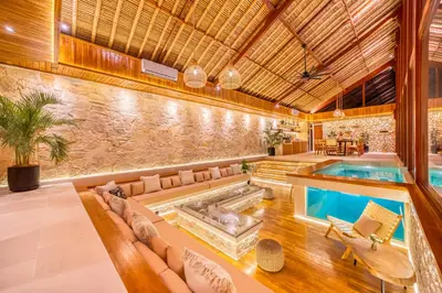 an indoor pool with a hot tub in a house at Villa Vienna - New 8BDR Jacuzzi Sauna and Cinema in Seminyak