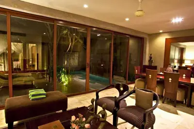 a living room with a large glass wall at Amani Entire 2 BR Private Pool Villa in Seminyak
