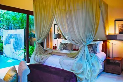 a bedroom with two beds and a large window at Amani Entire 2 BR Private Pool Villa in Seminyak