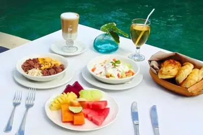 a white table topped with plates of food and drinks at Amani Entire 2 BR Private Pool Villa in Seminyak
