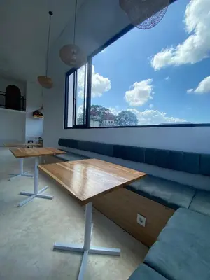 a living room with a table and a large window at WIJA's Bali Homestay in Legian