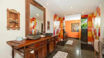 two sinks in a bathroom with colorful walls at Desa Roro Estate by Villa Finder in Canggu