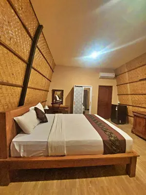 a bedroom with a large bed in a room at Yogasari Villa Seminyak in Seminyak