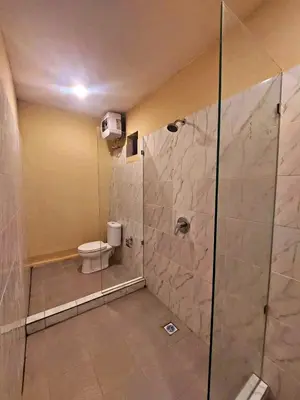 a bathroom with a shower with a toilet in it at Yogasari Villa Seminyak in Seminyak