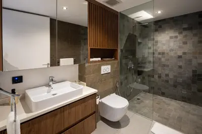 a bathroom with a sink and a toilet and a shower at Umalas Creek Villas in Canggu