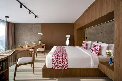a hotel room with a bed and a desk and a desk at Umalas Creek Villas in Canggu