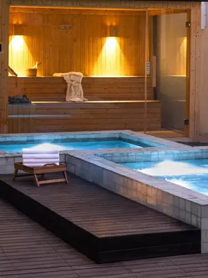 a swimming pool with a bench in front of it at Umalas Creek Villas in Canggu
