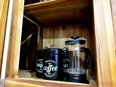 a coffee maker and a coffee pot in a wooden drawer at Peaceful Private 4 BR YY Bali Villa, Jimbaran Nusa Dua, In Central Kuta in Jimbaran