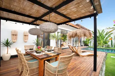 a patio with a table and chairs and a pool at 3 Bedrooms Luxury Umalas with private pool in Kerobokan