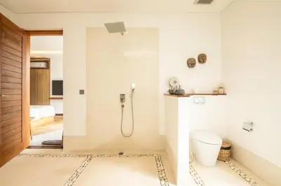 a bathroom with a shower and a toilet at Brand New 4br Villa 400 to Finns Canggu in Canggu