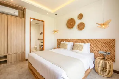 a bedroom with a large white bed and a mirror at Brand New 4br Villa 400 to Finns Canggu in Canggu