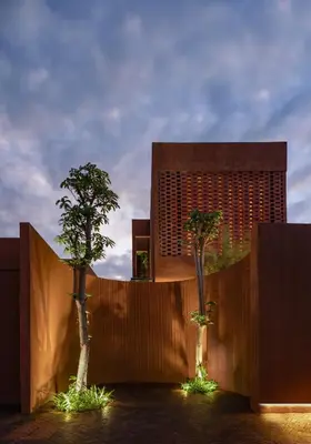 two trees in front of a building with lights at Kula Terra One Bedroom Villa in Kerobokan