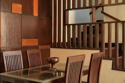 a dining room with a glass table and chairs at Bali Ula Villa in Nusa Dua
