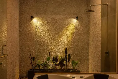 a bathroom with a sink and a wall with lights at Bali Ula Villa in Nusa Dua