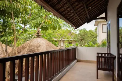 a balcony of a house with a thatch roof at Bali Ula Villa in Nusa Dua