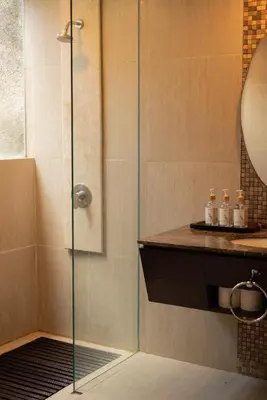 a shower with a glass door in a bathroom at Bali Ula Villa in Nusa Dua