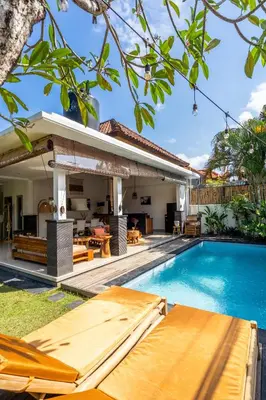 a villa with a swimming pool and a house at Kupu-Kupu Villa by iBali Management in Canggu