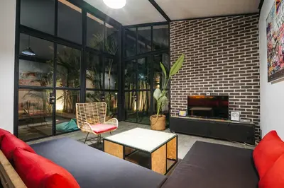 a living room with a couch and a table at Villa Costa Plana - 2 bedroom industrial private villa in Umalas, between Canggu & Seminyak in Seminyak