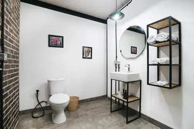 a bathroom with a white toilet and a sink at Villa Costa Plana - 2 bedroom industrial private villa in Umalas, between Canggu & Seminyak in Seminyak