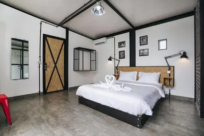 a bedroom with a large bed with a flower on it at Villa Costa Plana - 2 bedroom industrial private villa in Umalas, between Canggu & Seminyak in Seminyak