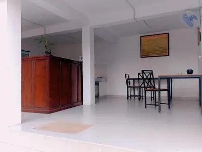 a kitchen and dining room with a table and chairs at WJ Guest house in Kerobokan