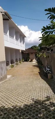 a courtyard of a building with a motorcycle parked next to it at WJ Guest house in Kerobokan