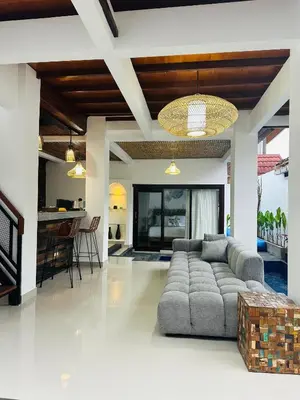a living room with a couch and a table at Villa Umah Seminyak in Seminyak