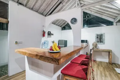 a kitchen with a counter with a bowl of fruit on it at Villa Laksmana 1 in Canggu