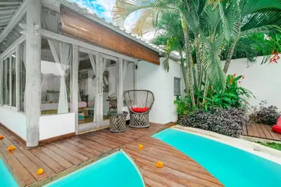 a villa with a swimming pool on a wooden deck at Villa Laksmana 1 in Canggu