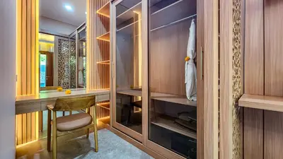 a dressing room with a chair and a closet at Casa De Gracia Sanur Beach by Nagisa Bali in Sanur