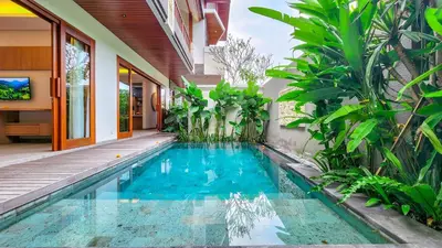 a swimming pool in the backyard of a house at Casa De Gracia Sanur Beach by Nagisa Bali in Sanur