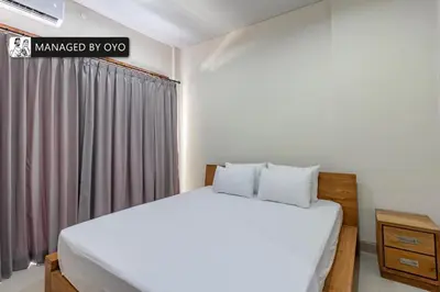 a bedroom with a white bed and a window at Collection O Near Seminyak Beach Formerly The Kumpi Hotel in Seminyak
