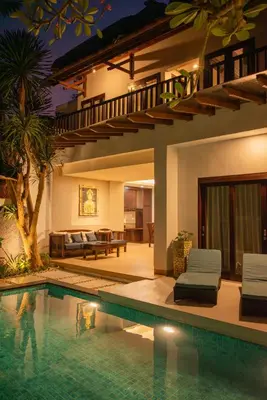 a villa with a swimming pool and a house at Bali Stile villa in Nusa Dua