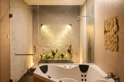 a bathroom with a white tub and a sink at Bali Stile villa in Nusa Dua