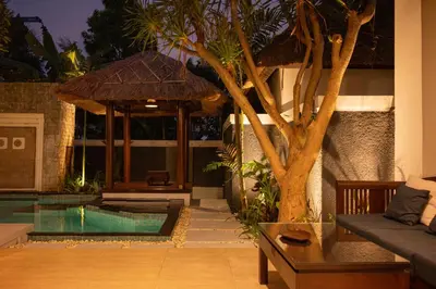 a living room with a pool and a tree at Bali Stile villa in Nusa Dua