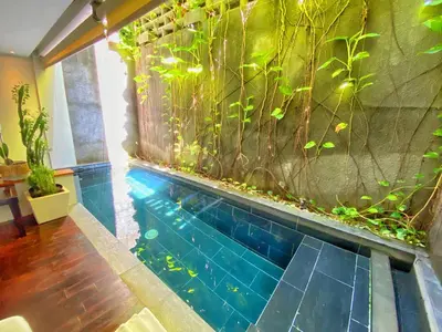 an indoor aquarium with a fish tank in a room at Venus Private Pool Kuta By iLys Collection in Kuta