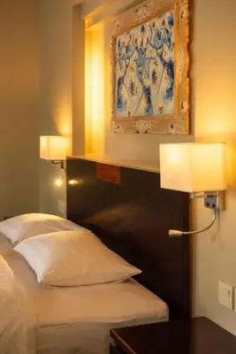 a bedroom with a bed and a painting on the wall at Balinese stile villa in Nusa Dua
