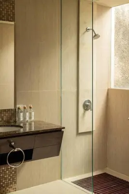 a shower with a glass door in a bathroom at Balinese stile villa in Nusa Dua