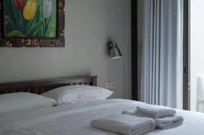 a bedroom with a bed with two towels on it at Terrace Mumbul in Nusa Dua