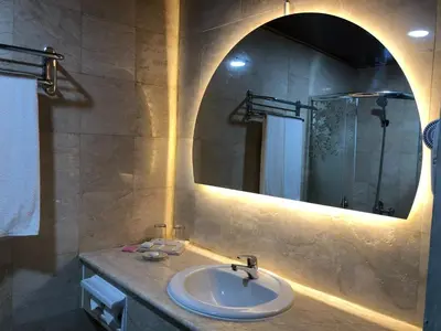 a bathroom with a sink and a mirror at The Tandibayang Hotel & Villas in Legian