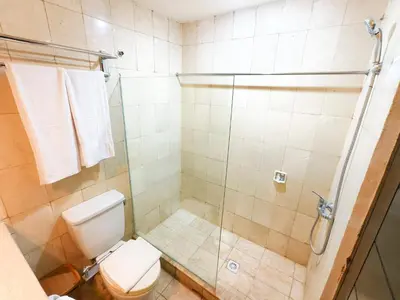 a bathroom with a toilet and a shower at The Tandibayang Hotel & Villas in Legian