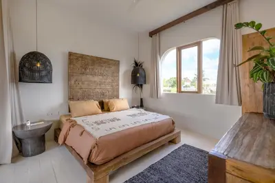 a bedroom with a bed and a sink and a window at Villa Casa Eldorado by BaliSuperHost in Kerobokan
